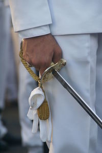 Midsection of man holding sword