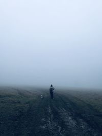 Fog woman dog empty field