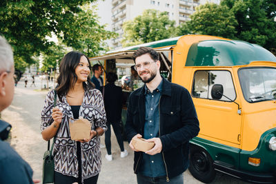 Young couple standing on bus