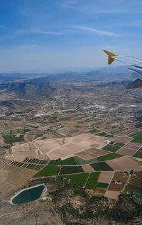 Aerial view of agricultural landscape against sky