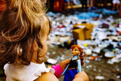 Rear view of girl with toy