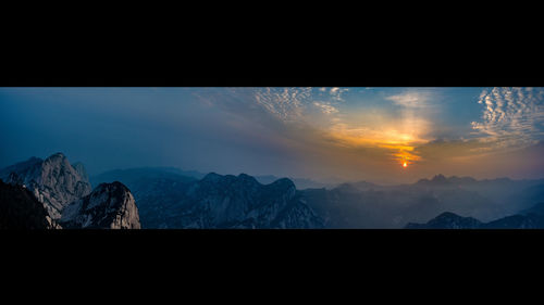 Scenic view of mountains against cloudy sky