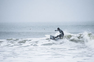 Man surfing during winter snow