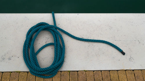 High angle view of rope tied on pier