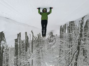 Full length of man standing on snow covered landscape