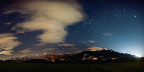 Scenic view of mountains against sky at night