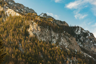 Low angle view of rocky mountains against sky