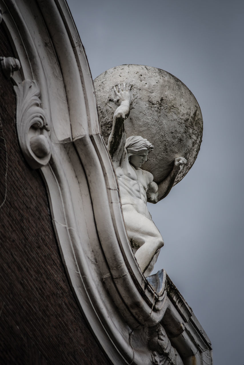 CLOSE-UP OF STATUE AGAINST SKY