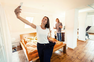 Young woman using phone at home