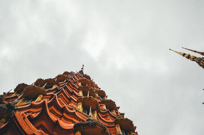 Low angle view of sculptures on building against sky