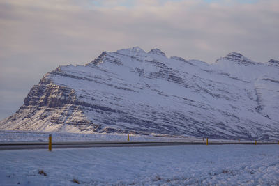 Scenic view of snow covered mountains against sky