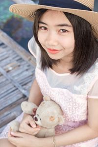 Portrait of smiling girl holding hat