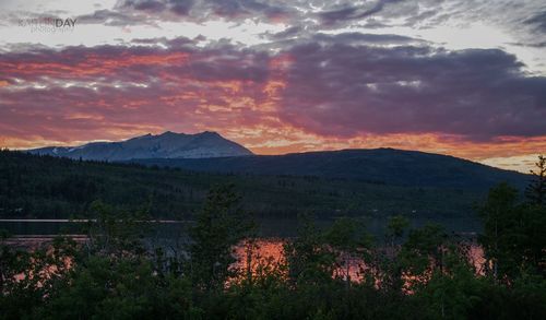 Scenic view of mountains against orange sky