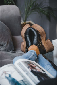 Close-up of man relaxing on sofa at home