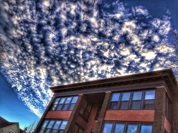 Low angle view of built structure against cloudy sky