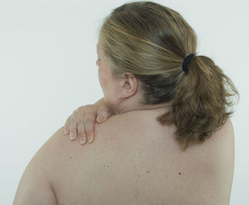 Rear view of woman against white background