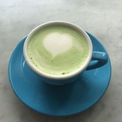 High angle view of matcha tea in cup on table