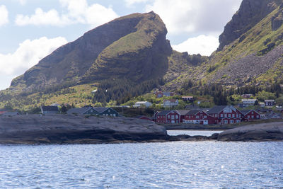 Scenic view of sea and mountains against sky