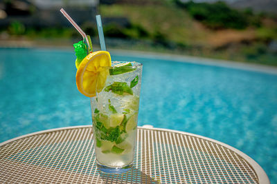 Close-up of drink on swimming pool