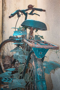 Close-up of rusty bicycle against wall