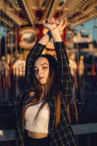 Portrait of beautiful young woman standing outdoors