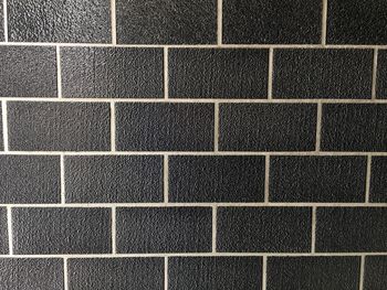 Full frame shot of black tiled wall