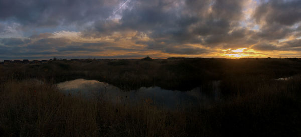 Scenic view of land against sky during sunset