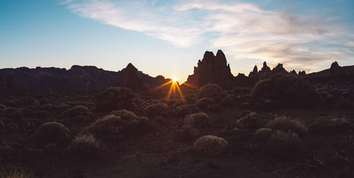 Panoramic view of rocks against sky during sunset