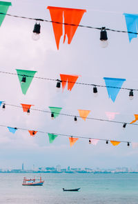 Low angle view of decorations hanging against sky