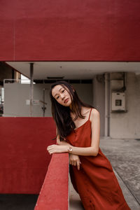 Portrait of young woman sitting outdoors