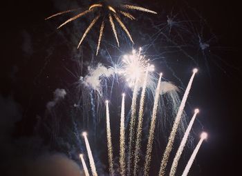 Low angle view of firework display at night