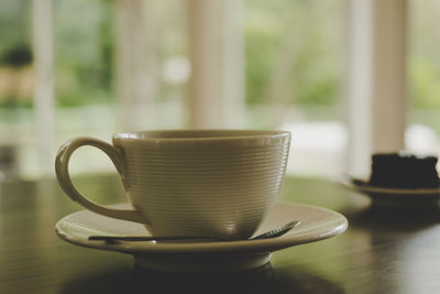 Hot americano coffee in a white cup at coffee shop.