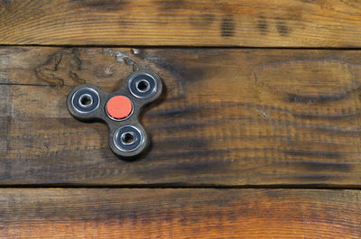 High angle view of fidget spinner on wooden table