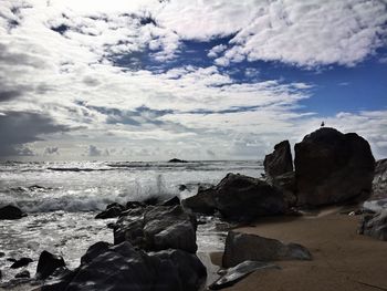 Rocks on beach against sky
