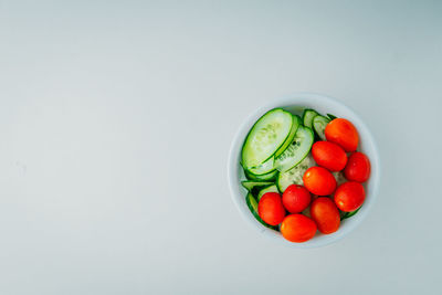 Directly above shot of strawberries in bowl against white background