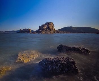 Scenic view of sea against clear blue sky