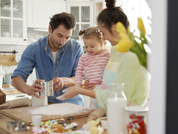 Family preparing food in kitchen