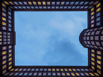 Low angle view of modern building against blue sky