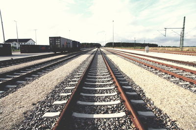 Railroad tracks against sky on sunny day