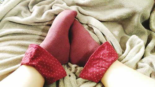 Low section of person with legs on bed