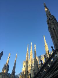 Low angle view of buildings against blue sky