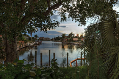 Sunrise over a waterway leading to the ocean near vanderbilt beach in naples, florida.