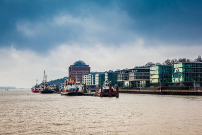 Tugboats docked at the hamburg port on the banks of the elbe river