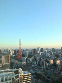 Aerial view of buildings in city against sky