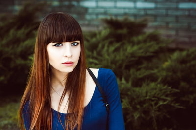 Portrait of young woman sitting outdoors