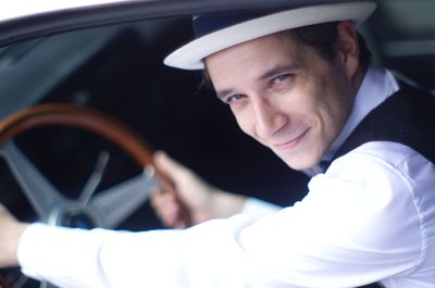 Portrait of young man in car