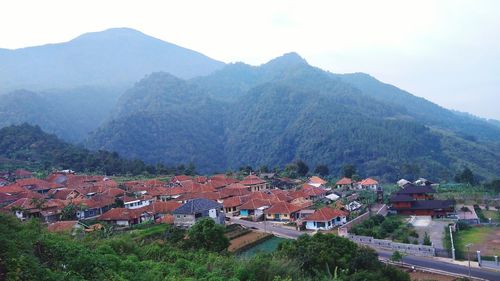 High angle view of houses and mountains against sky