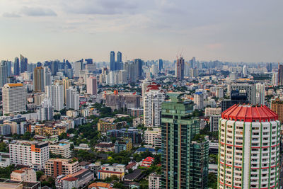 Aerial view of buildings in city against sky