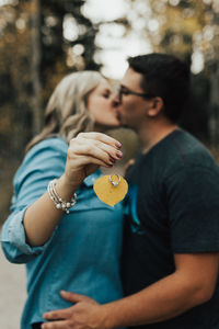 Midsection of couple holding hands