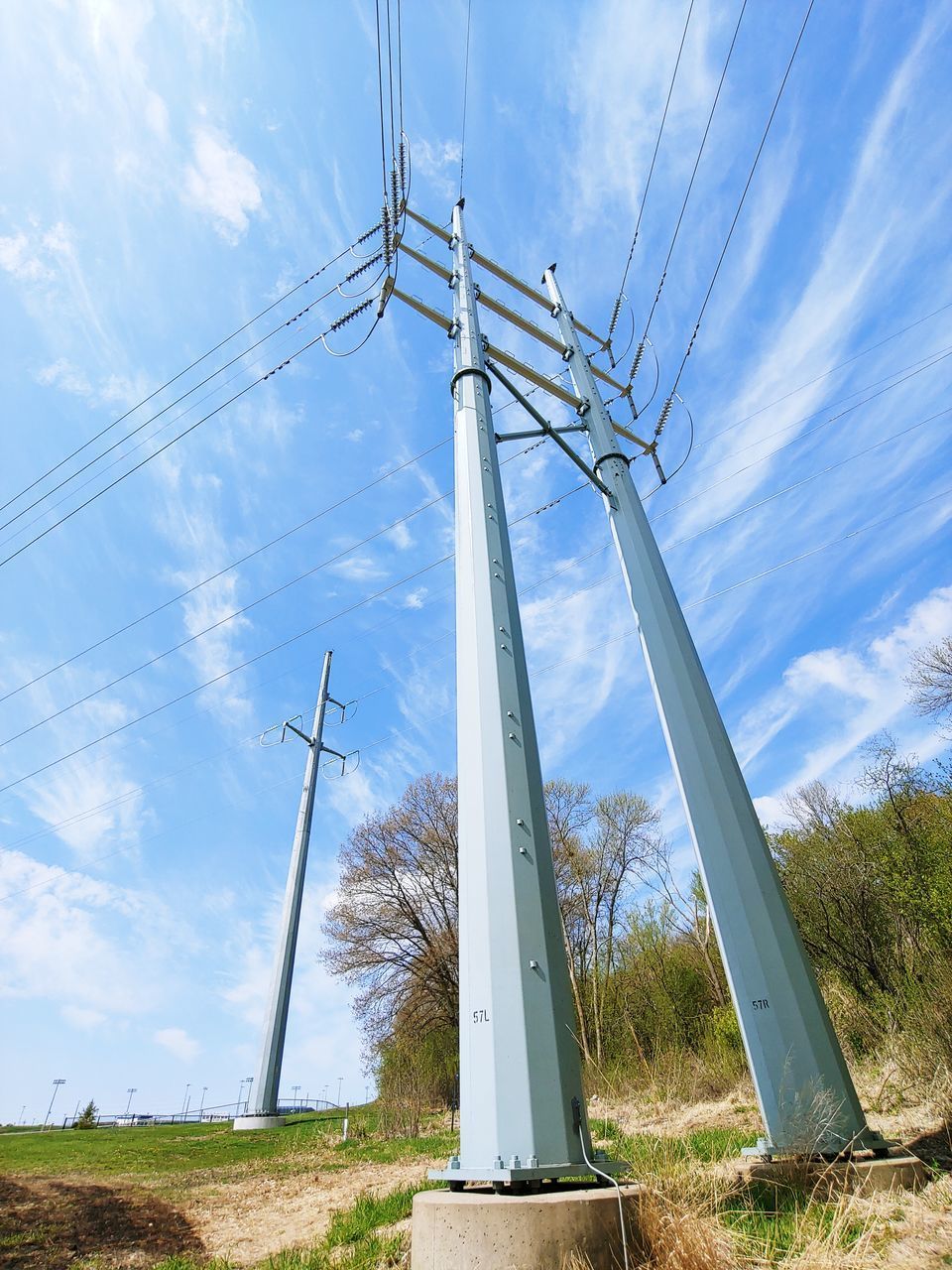 LOW ANGLE VIEW OF WIND TURBINES ON LAND